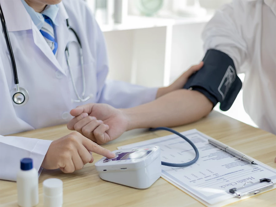 Affordable DOT physical exam in Mid West with doctor using blood pressure monitor