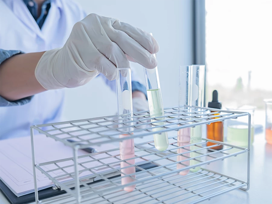 Lab technician handling test tubes for DOT alcohol and drug test in Gulfton