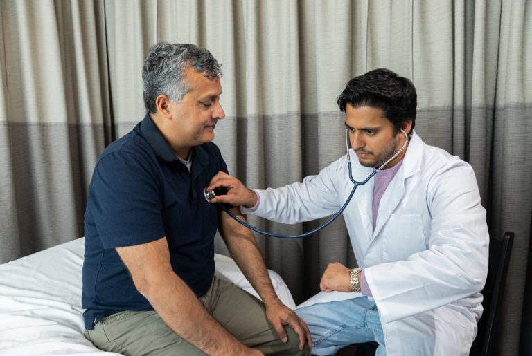 Certified medical professional performing a heart and lung screening for a driver’s DOT physical Houston certification.