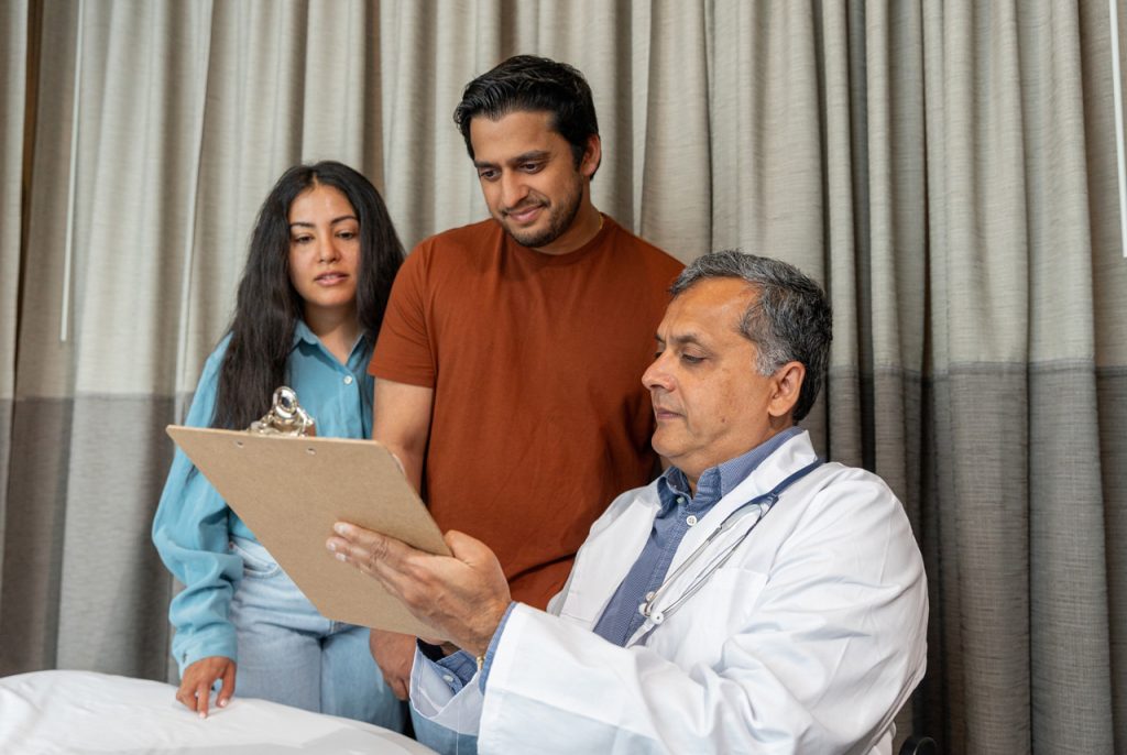 A medical examiner reviews DOT physical Houston results with a driver and partner to confirm FMCSA health compliance.