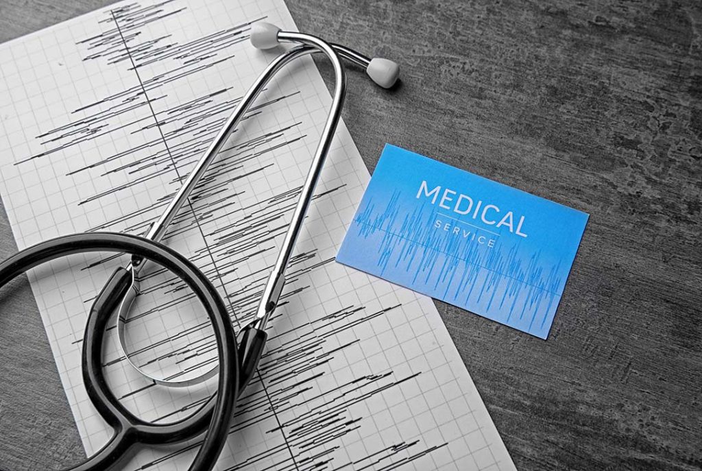 EKG printout and stethoscope used by an accredited FMCSA Medical Examiner Houston for CDL certification.