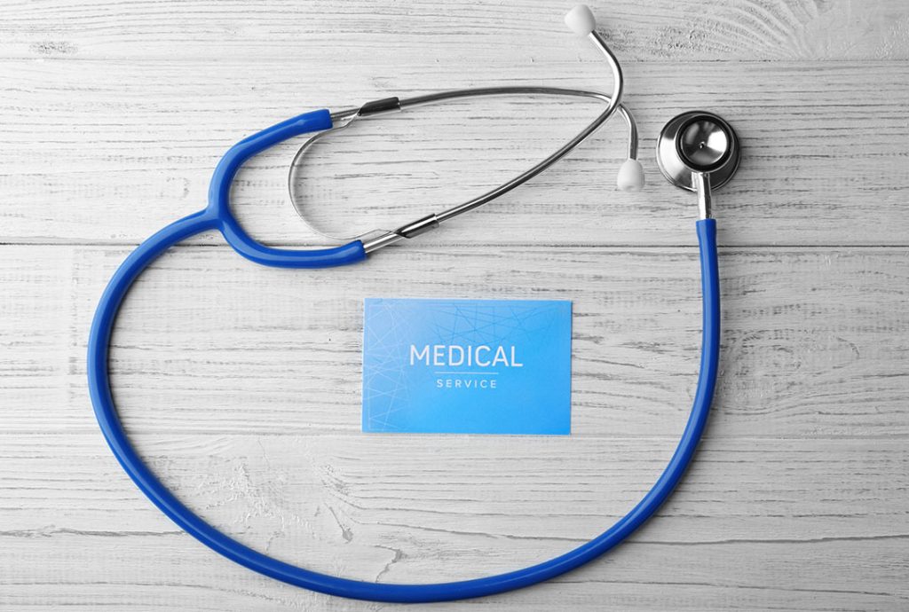 Stethoscope and a medical service card representing the comprehensive physical examination provided by a FMCSA Medical Examiner Houston.
