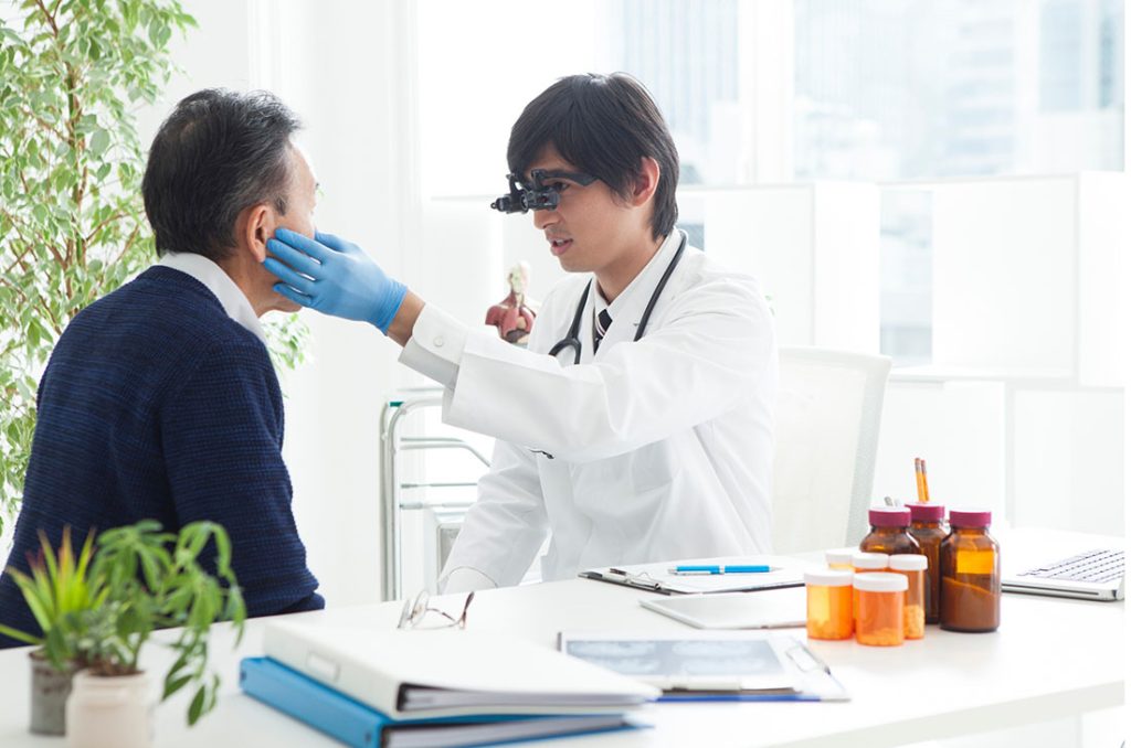 FMCSA Medical Examiner Houston specialist conducts a thorough oral and facial medical evaluation.