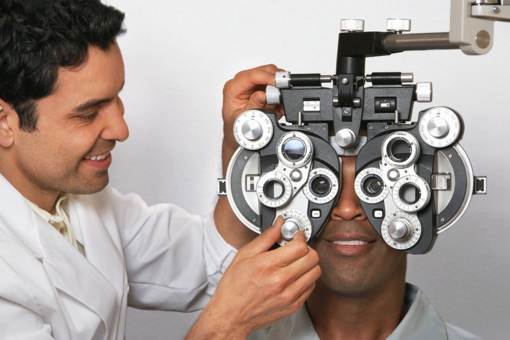 Optometrist performing an eye exam for drivers to meet medical requirements for a DOT Physical Houston TX.