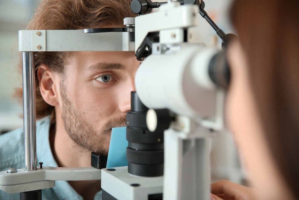 Slit lamp vision exam with chin rest—DOT Physical Houston TX eyesight screening to meet CDL driver medical certification