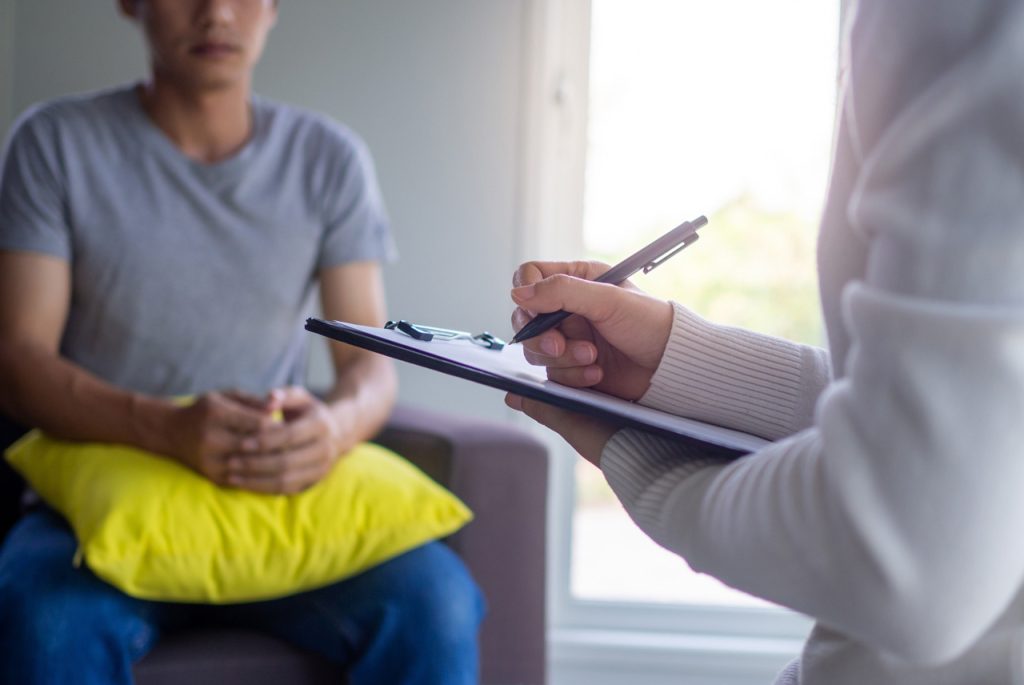 Healthcare provider documenting a driver medical exam for a DOT physical open Saturday Houston during a consultation.