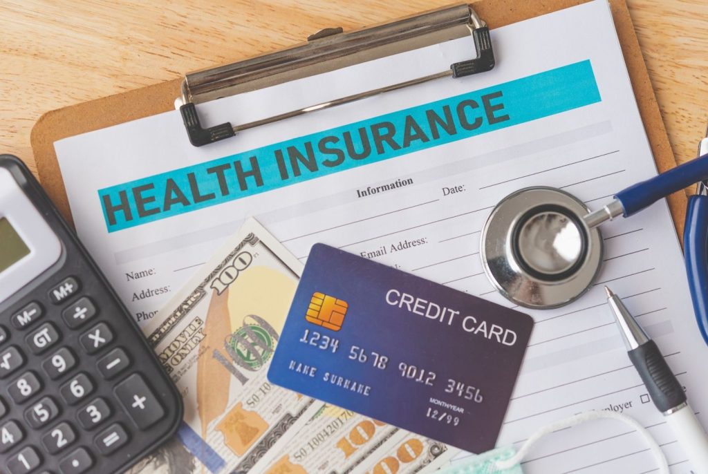 A calculator and money on a medical form representing the affordable cost of getting your cdl medical card houston.