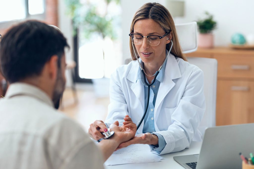 A DOT certified medical examiner Houston performs a physical exam on a driver to ensure commercial safety compliance.