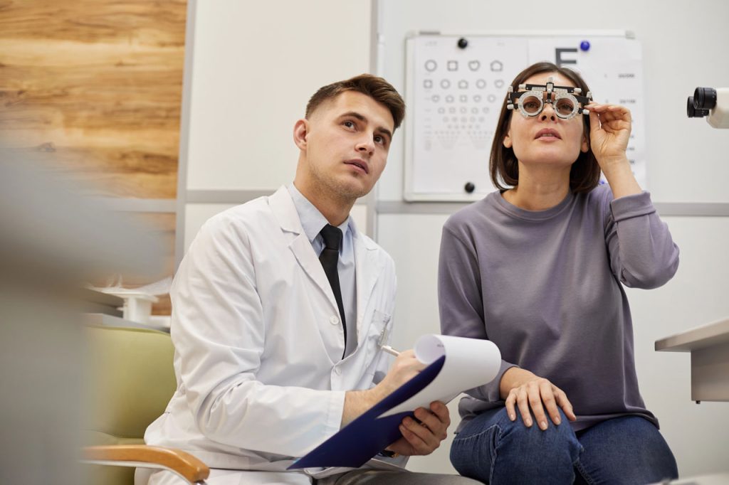 Doctor testing a driver's eyesight for a same day DOT physical Houston using specialized medical trial frames.