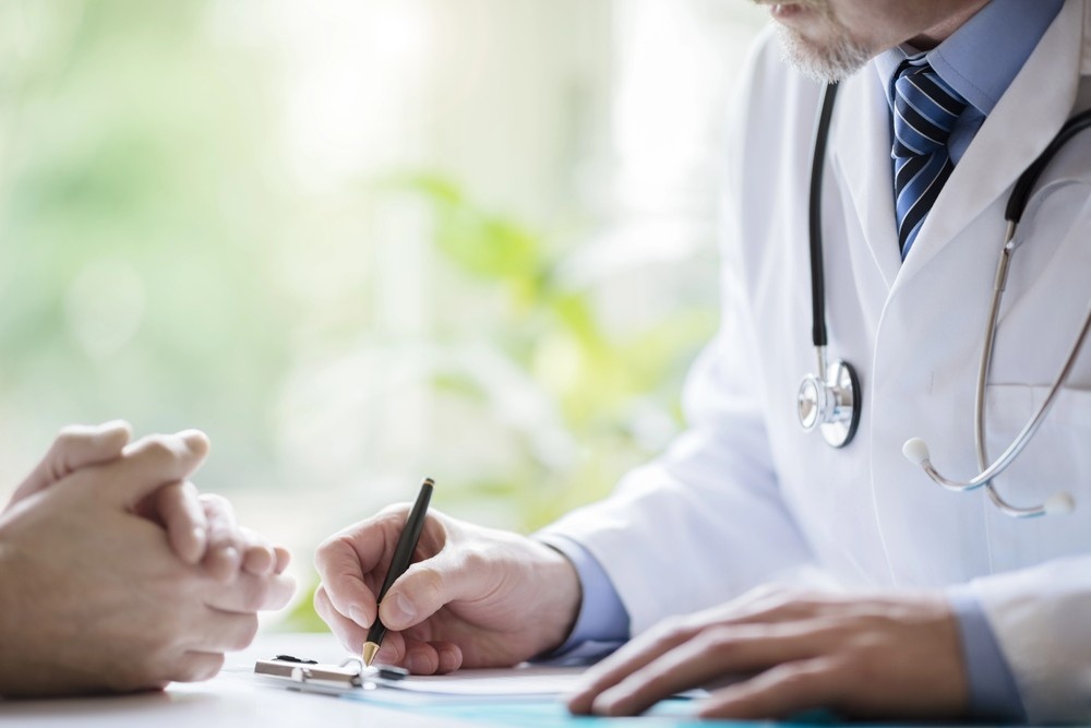 A Houston doctor completes the necessary official paperwork for a certified Dot drug test houston at a clinic desk. 