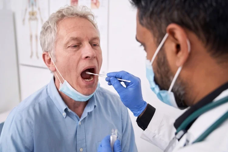 Certified DOT medical exam Houston drug and alcohol testing using a mouth swab on a commercial driver at a clinic.