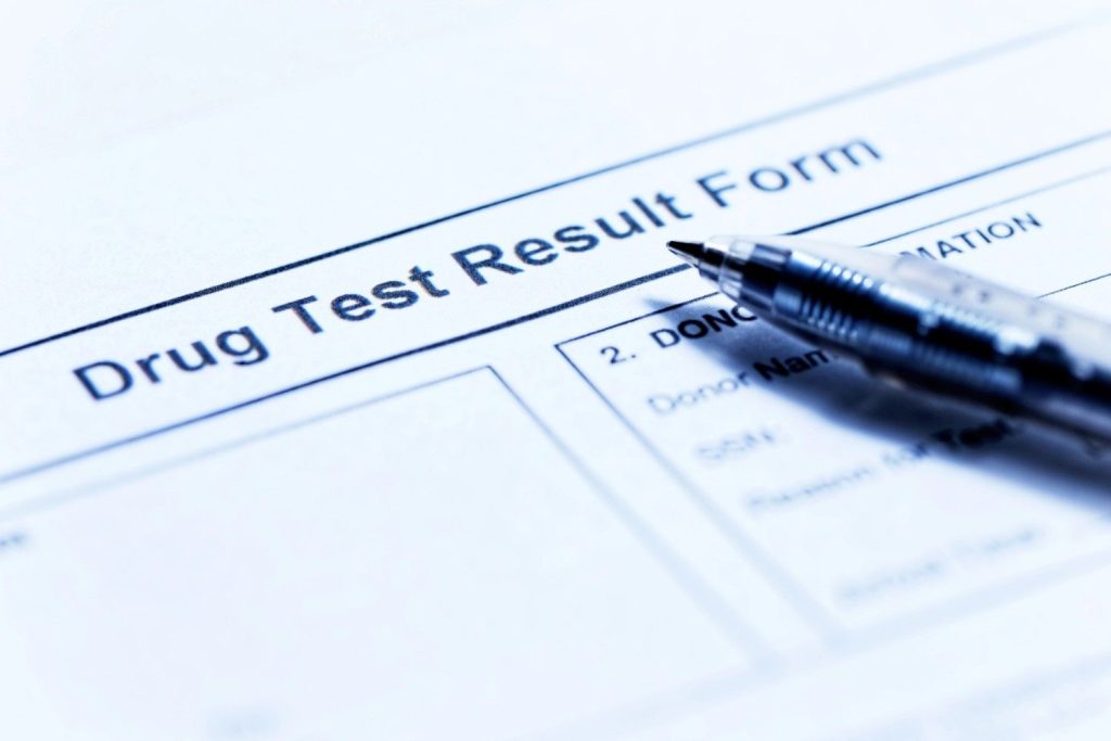 Official DOT drug test Houston result form with a pen, ready for medical review and compliance documentation.