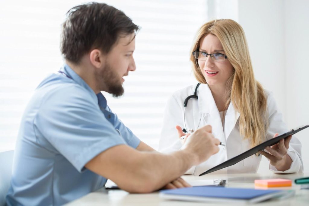 Medical practitioner discussing medical history form during a commercial driver DOT physical Houston Tx exam. 