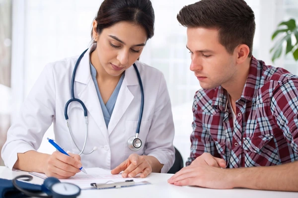 Certified medical examiner reviewing the official health history paperwork for a driver DOT physical Houston Tx.